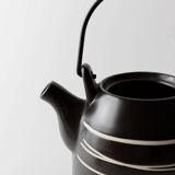 Vintage ceramic teapot from the 1980s, black with white stripes and a metal handle.