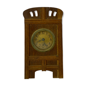 Fireplace clock of oak and the dial is of brass, from around the 1920s