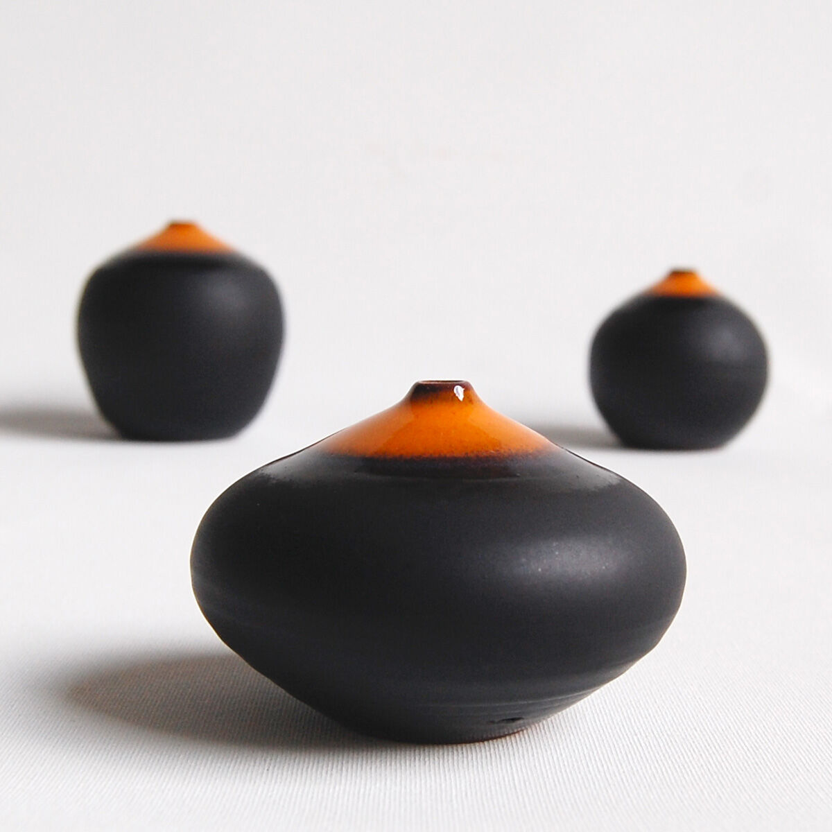Trio of miniature black and orange ceramics Antonio Lampecco