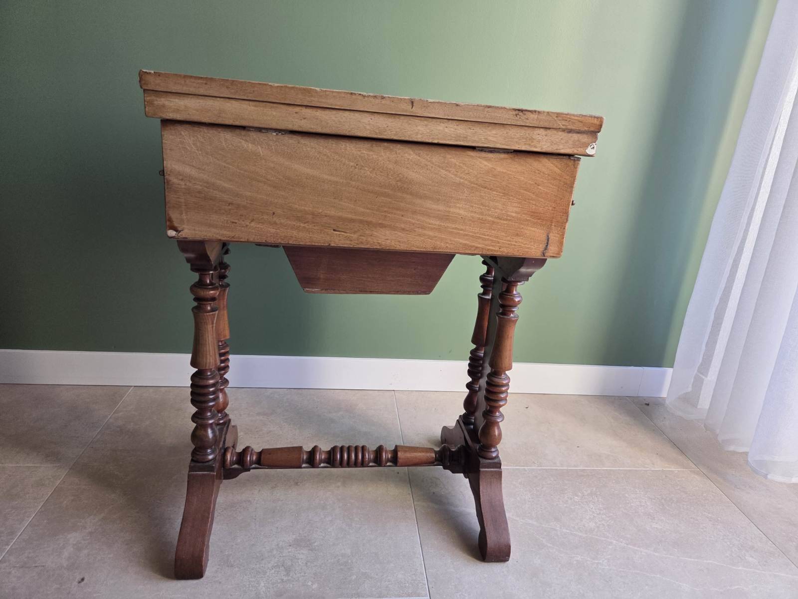 Antique wooden sewing cabinet with mirror and storage.