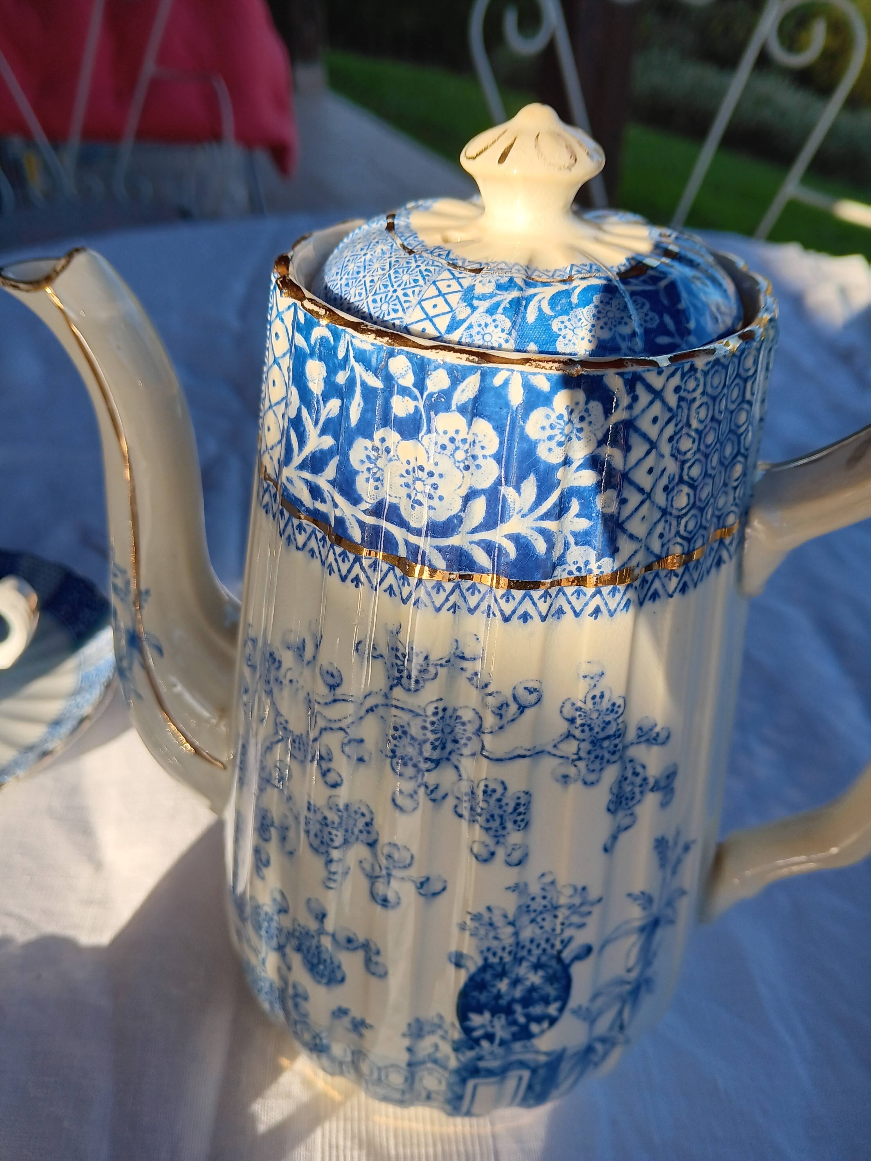 Old coffee service Lunéville with blue lace decoration.