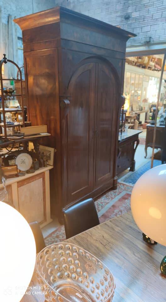 A walnut wardrobe with marquetry and boxwood stringing, dating from the Consulate period, circa 1810.
