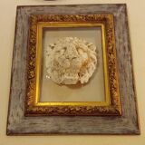 Antique gilded frame with stone lion head ornament on plexiglass