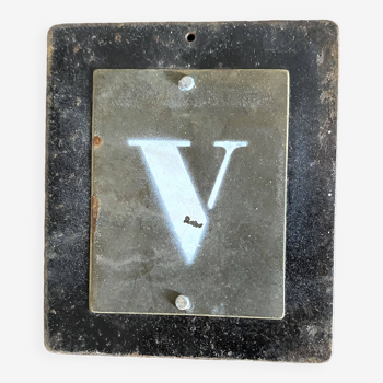 Letter V on brass and metal plates
