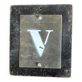 Letter V on brass and metal plates