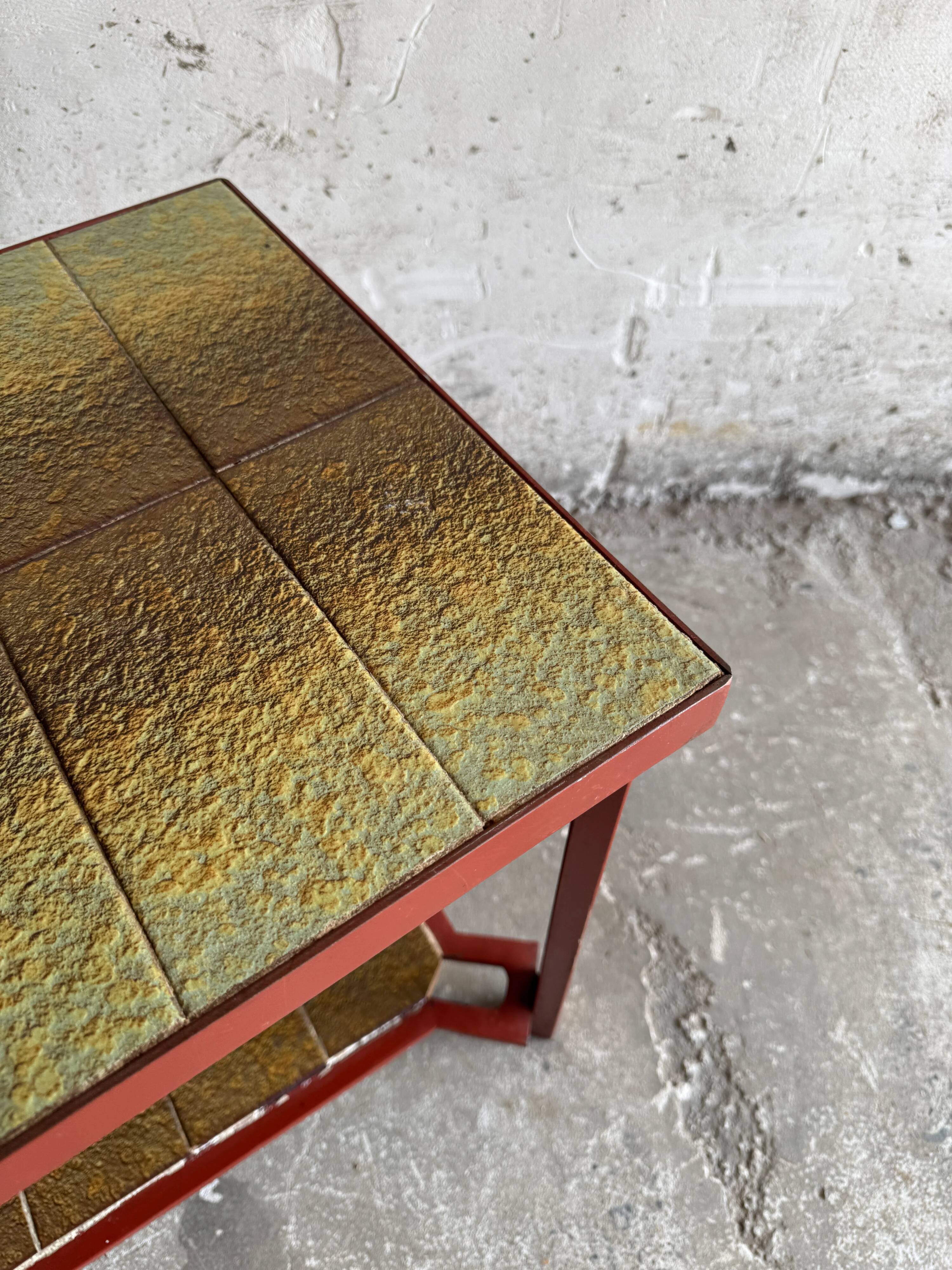 Vintage terracotta-red metal side table with glazed brown-green ceramic tile surfaces