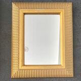 Mirror with striated and gilded decor