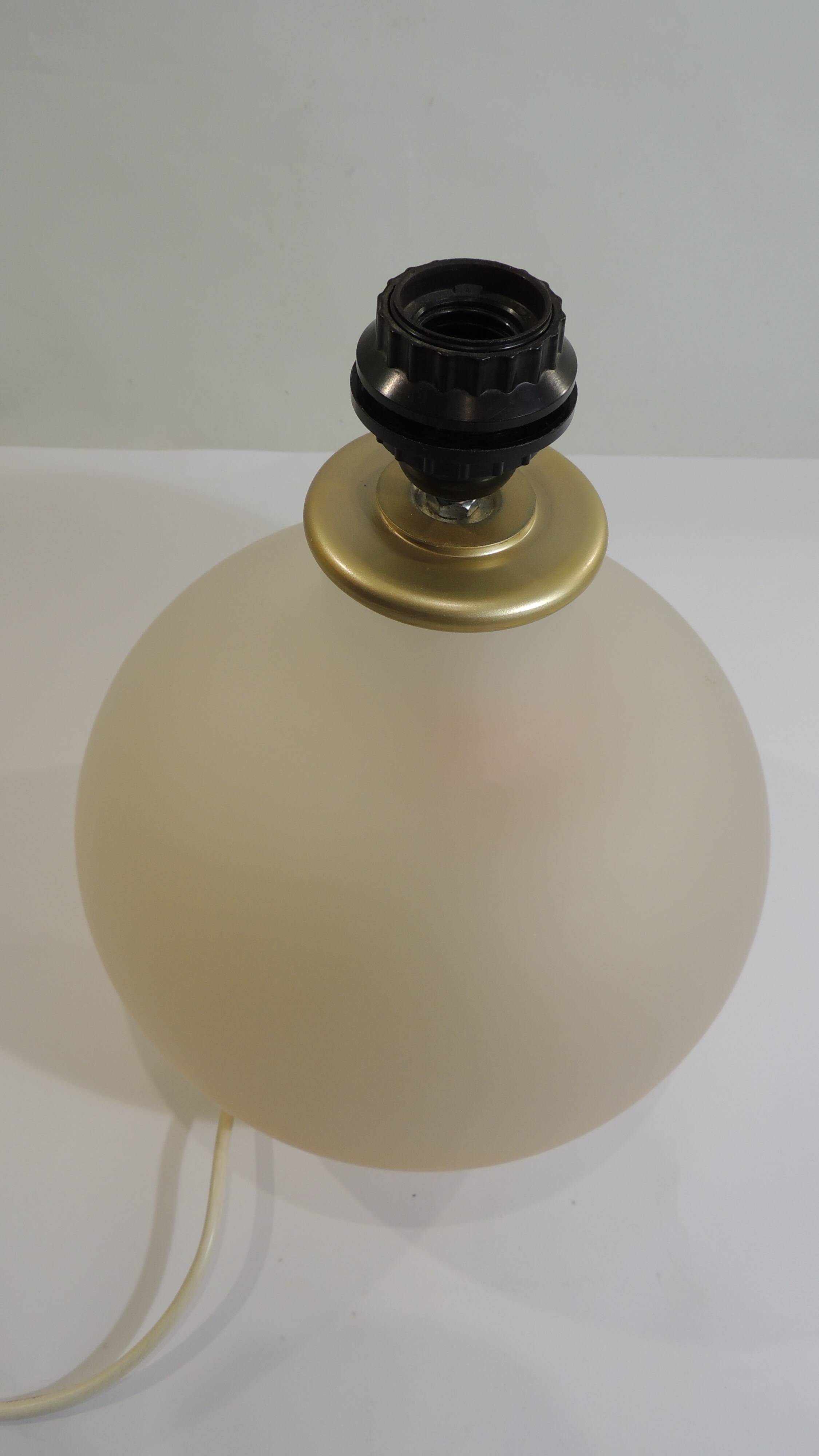 Vintage frosted glass lamp, round globe, elegant design, soft light.