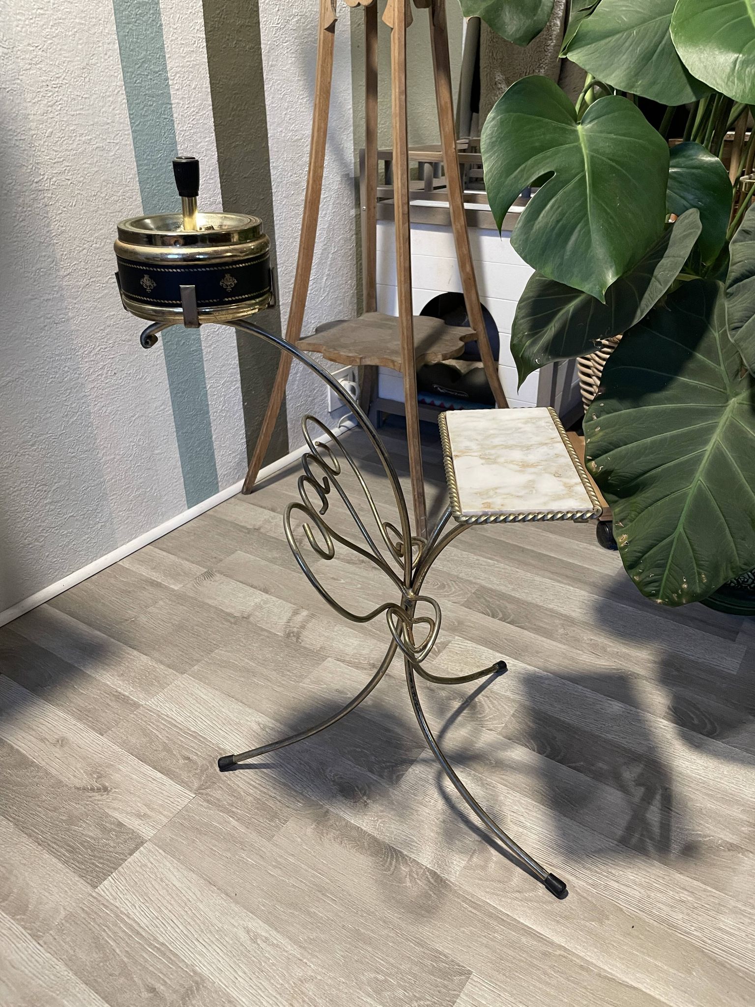 Gold wrought iron ashtray on legs with magazine rack and marbled shelf