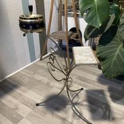 Gold wrought iron ashtray on legs with magazine rack and marbled shelf