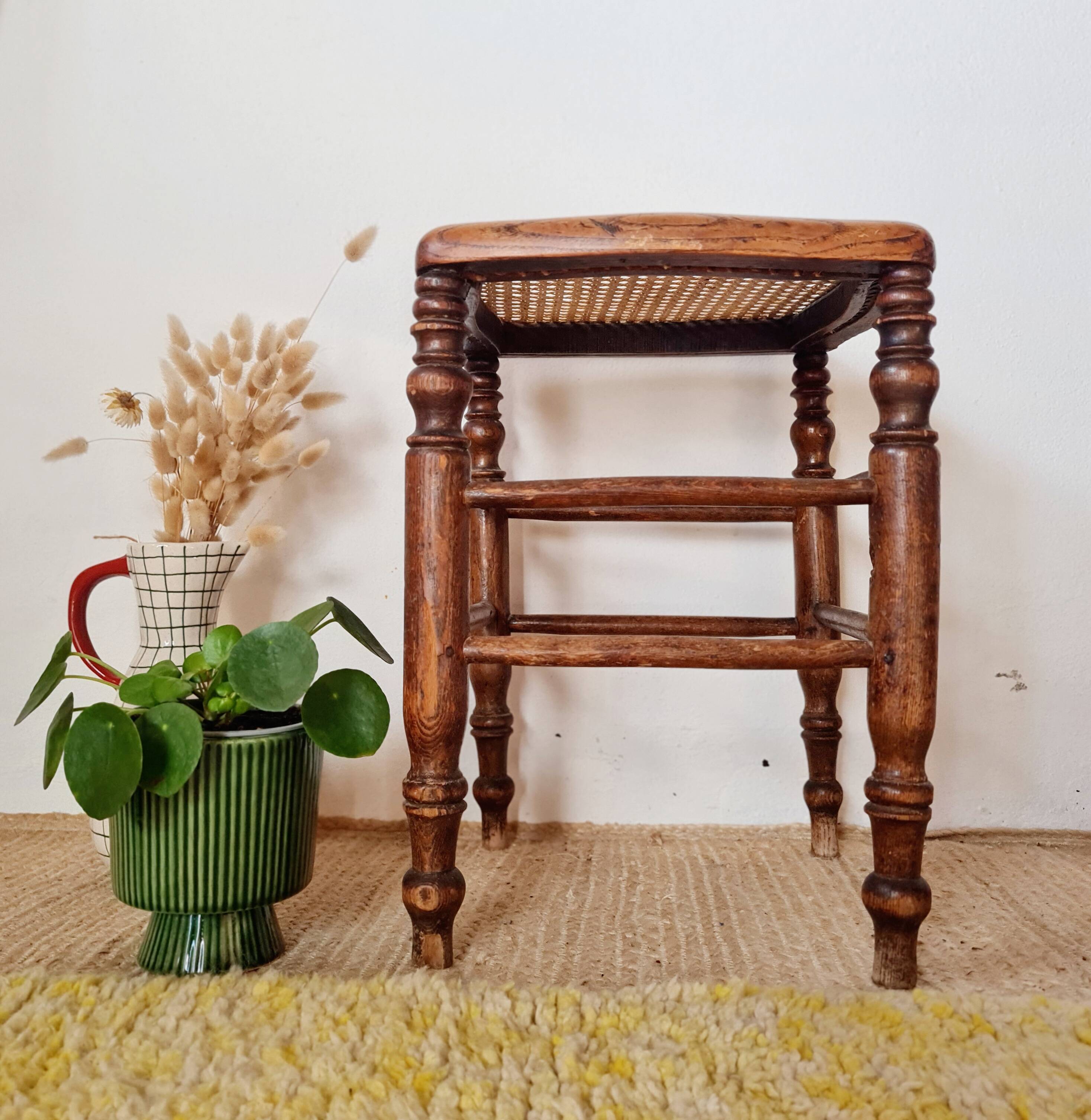 Wooden stool with cane seat