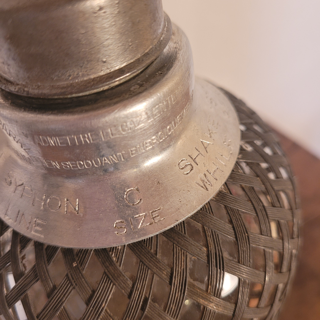 Old glass and metal siphon