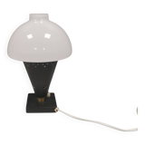 Small stylish table lamp with perforations and milky white opal glass shade