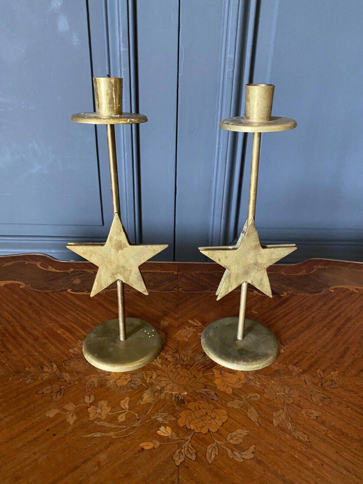 Pair of brass candlesticks decorated with 20th century stars