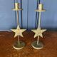Pair of brass candlesticks decorated with 20th century stars
