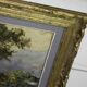 large painting of lake and countryside
