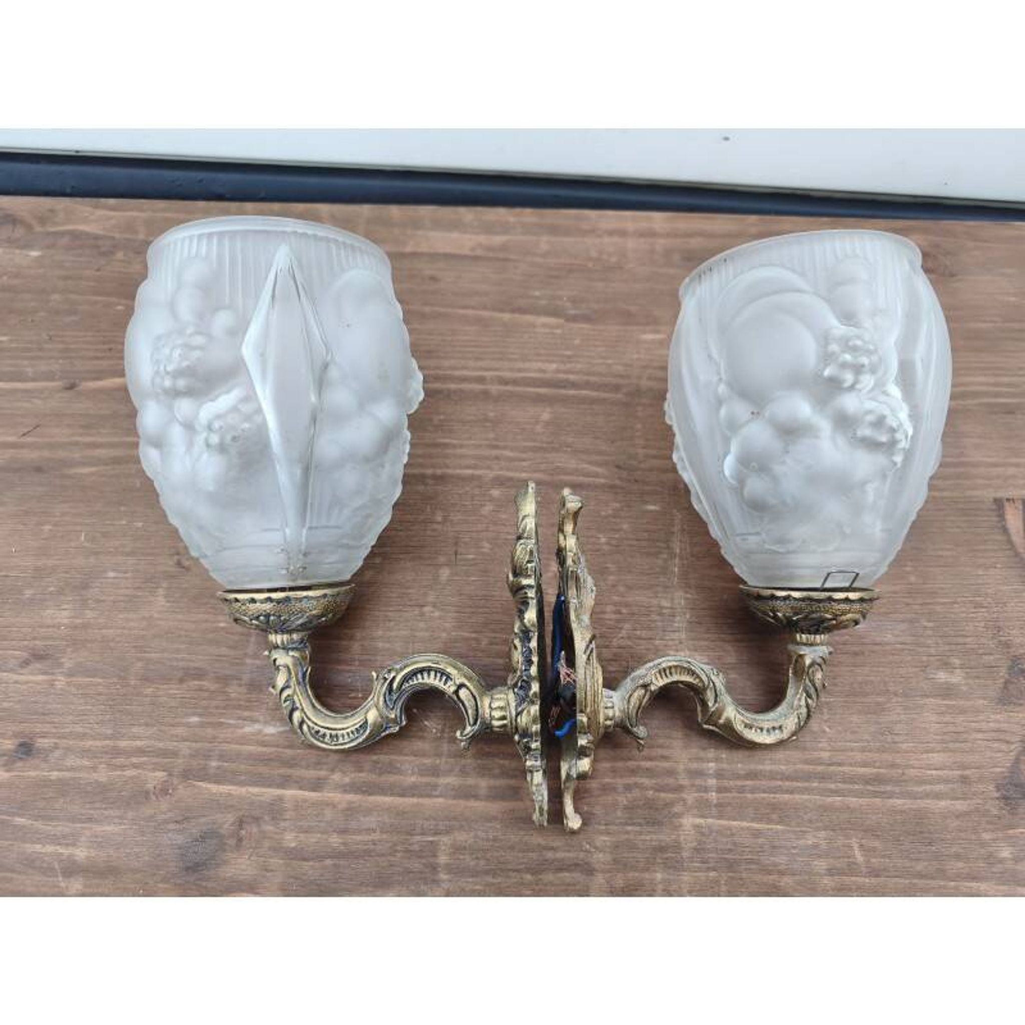 Pair of brass wall lights and glass paste.