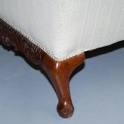 Three-seater canapé carved from solid walnut with claw feet.