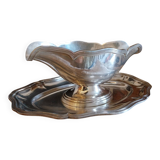Sauce boat on a scalloped tray in silver metal