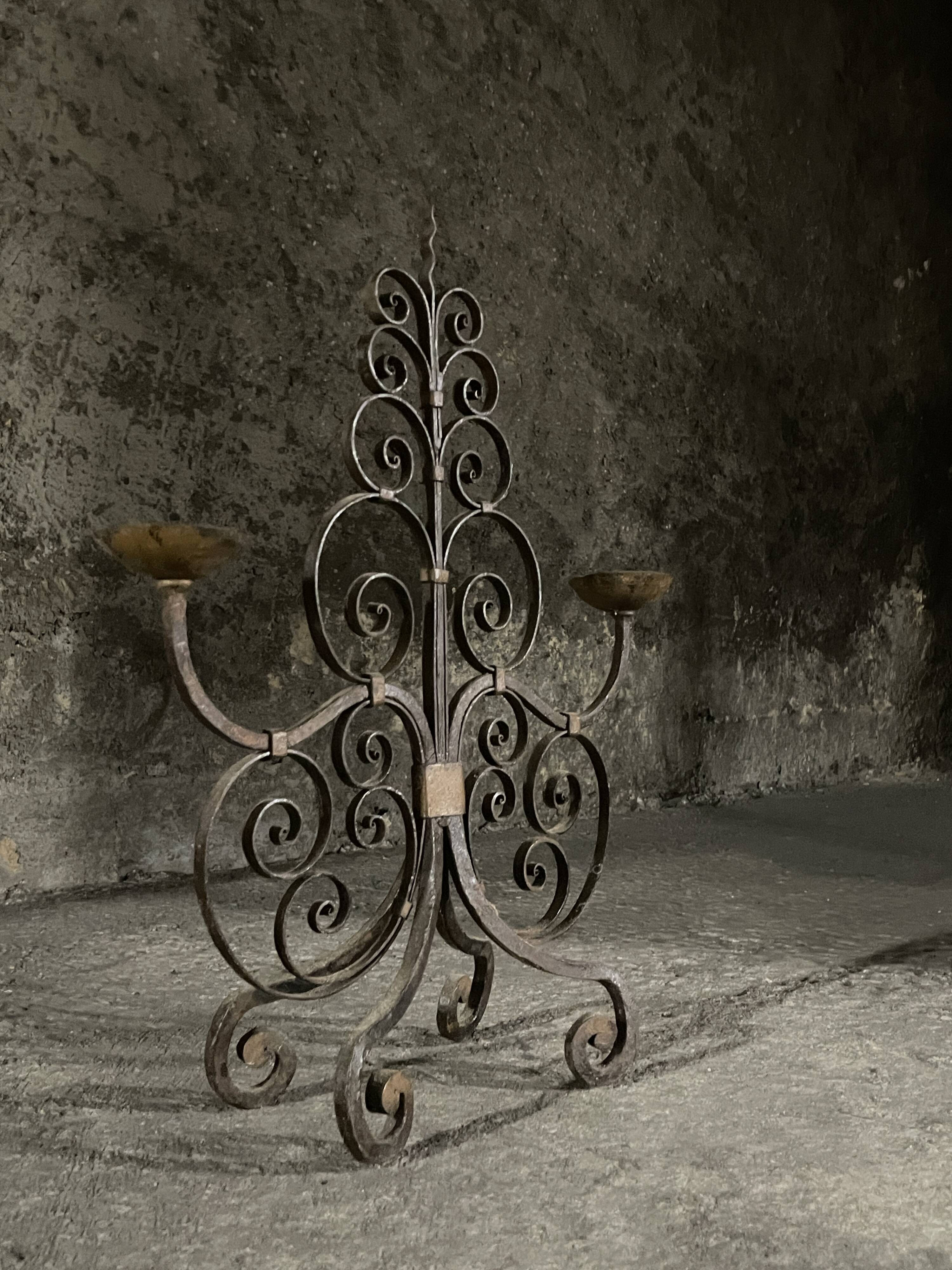 Pair of French wrought iron candelabra from the 19th century.