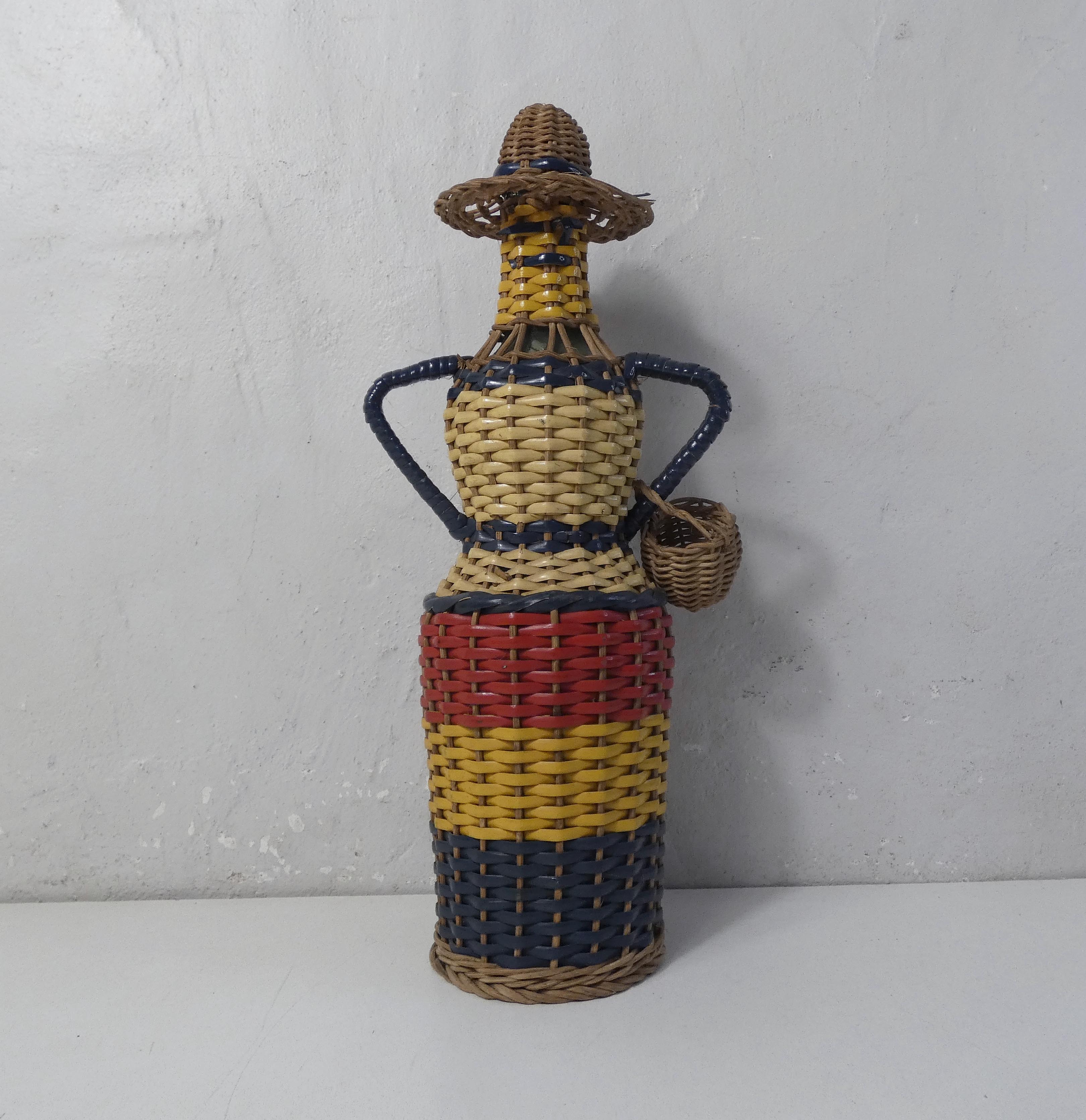 Old bottle dressed in scoubidou style rattan