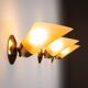 Set of three brass sconces with decorated yellow glass shades