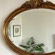 Antique oval gilt mirror.