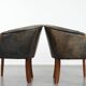 Set of two cowhide and wooden tub chairs with a sturdy colour scheme