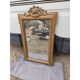 19th-century mirror in gilded wood and stucco.