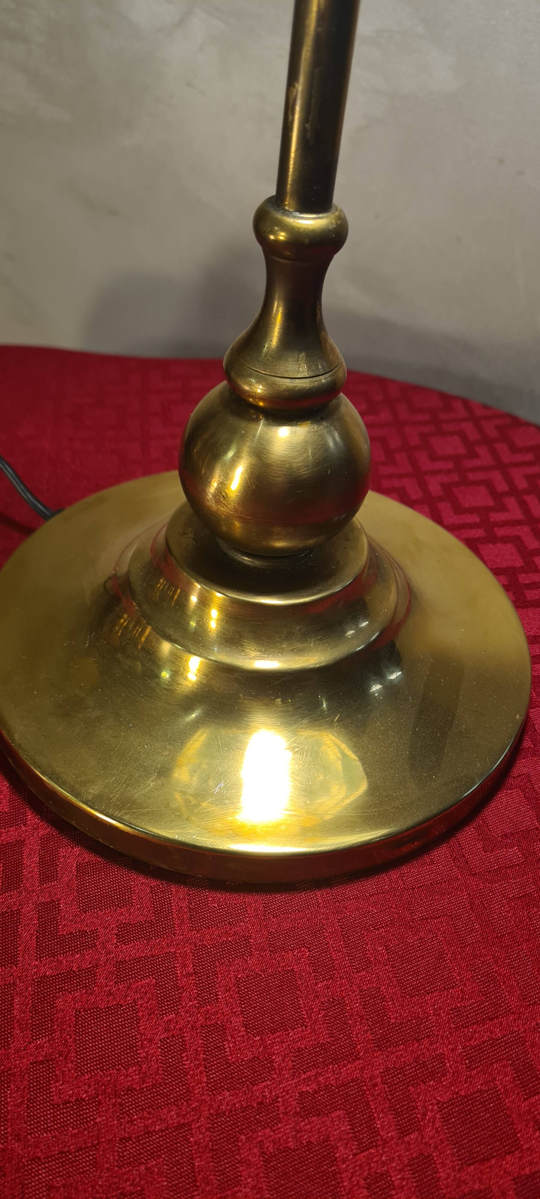 brass lamp with green stained glass shade.