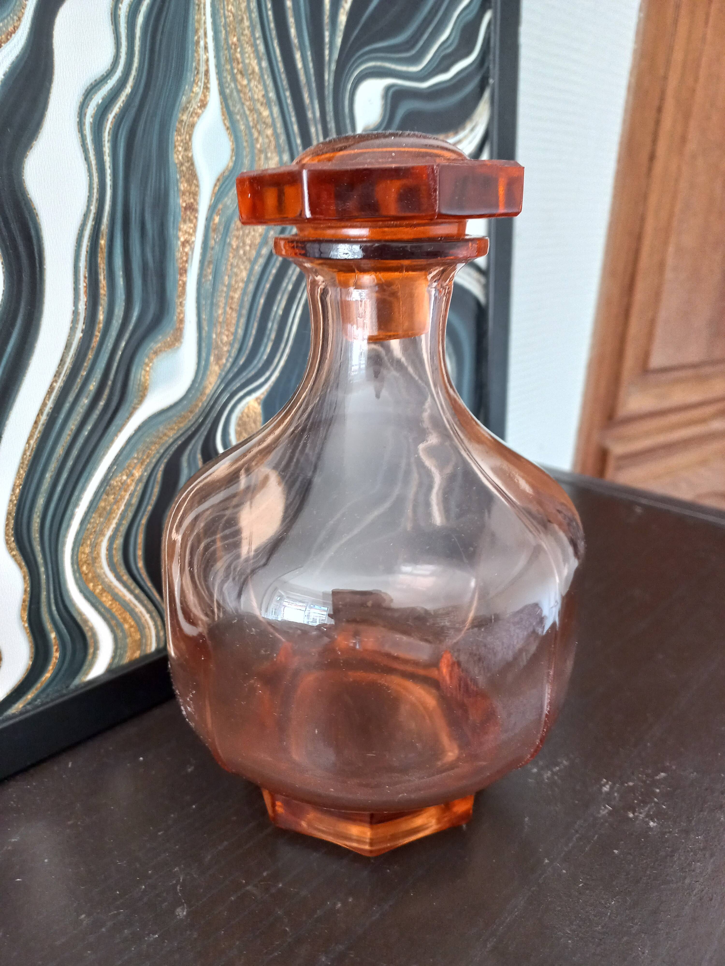 Vintage glass carafe in pink-orange, retro-chic style.