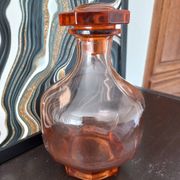 Vintage glass carafe in pink-orange, retro-chic style.