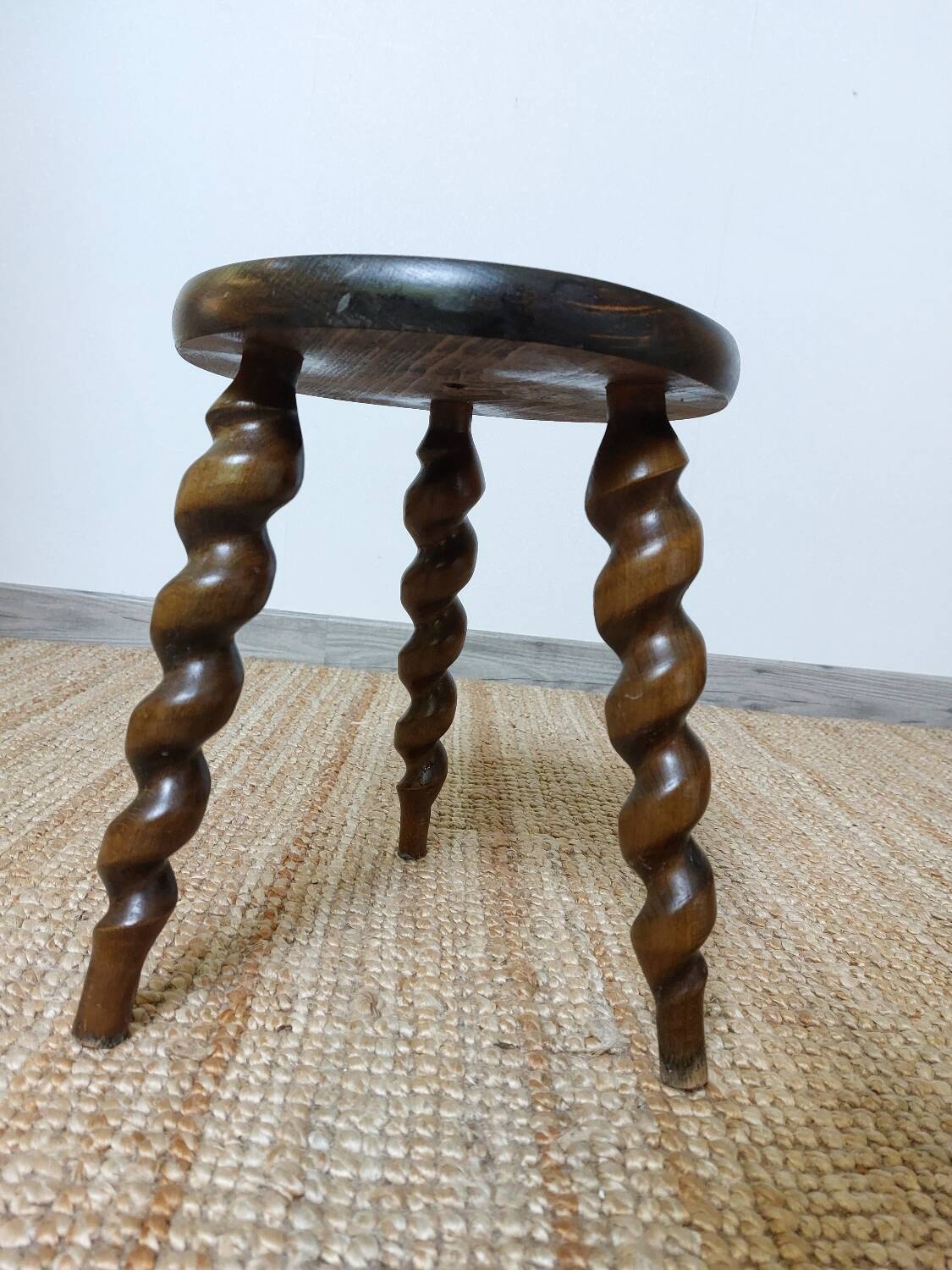 Wooden tripod stool with twisted legs