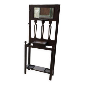 Antique brown wooden coat rack with mirror and umbrella stand, 1900 style.