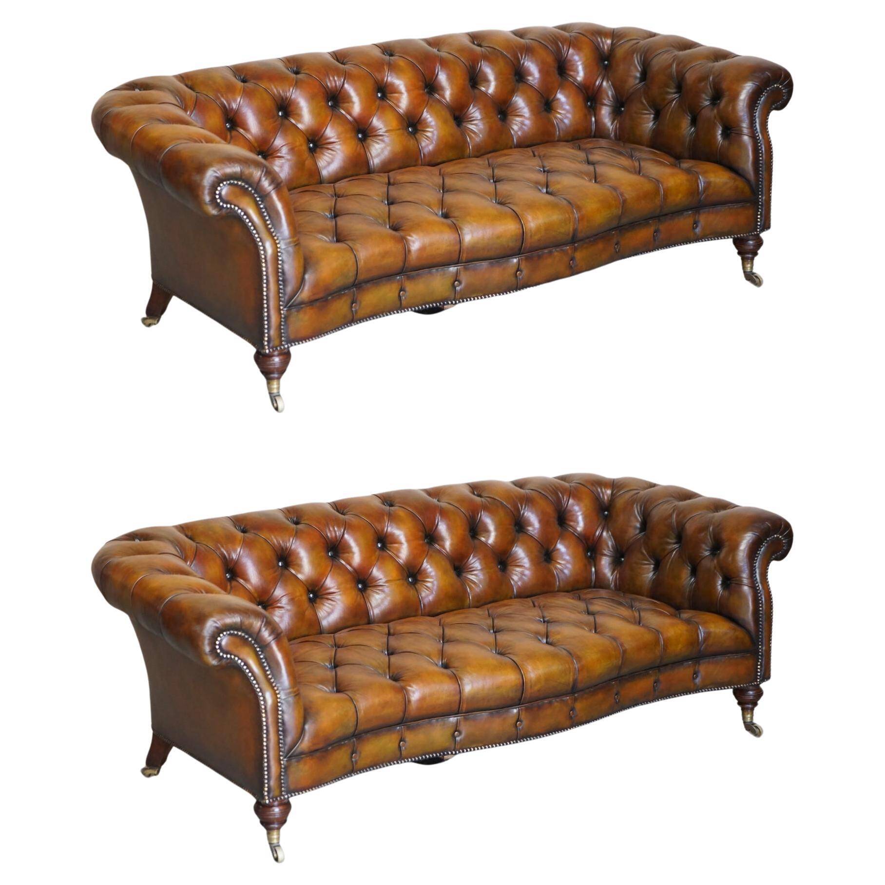 Pair of leather Chesterfield sofas by Howard & Sons