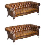 Pair of leather Chesterfield sofas by Howard & Sons