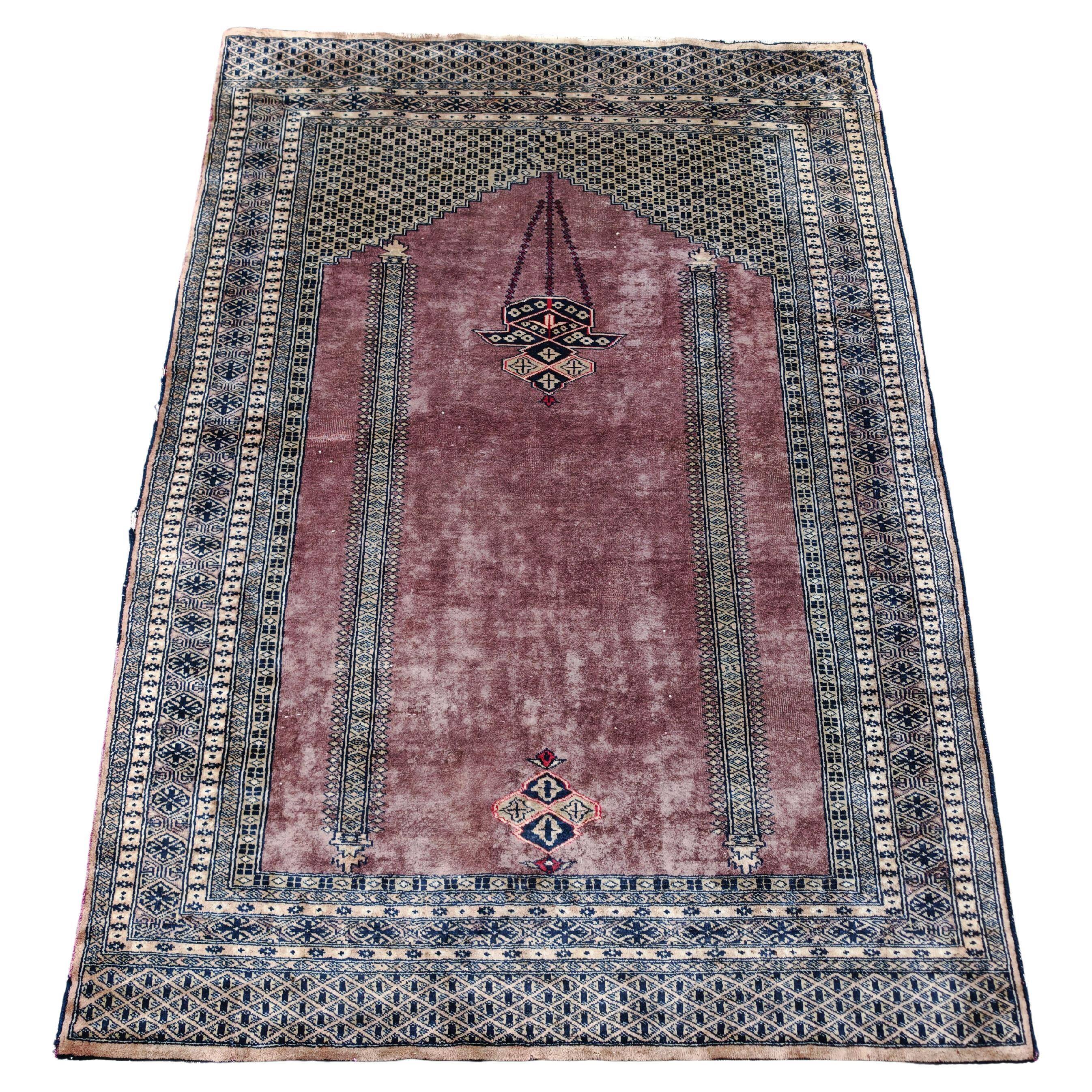 Vintage Anatolian prayer rug made of hand-knotted wool.
