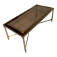 Rectangular neoclassical coffee table in gilded brass with a glass top.