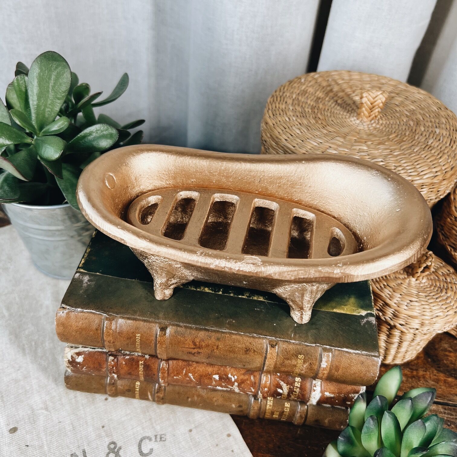 Cast iron soap dish in the shape of a bathtub