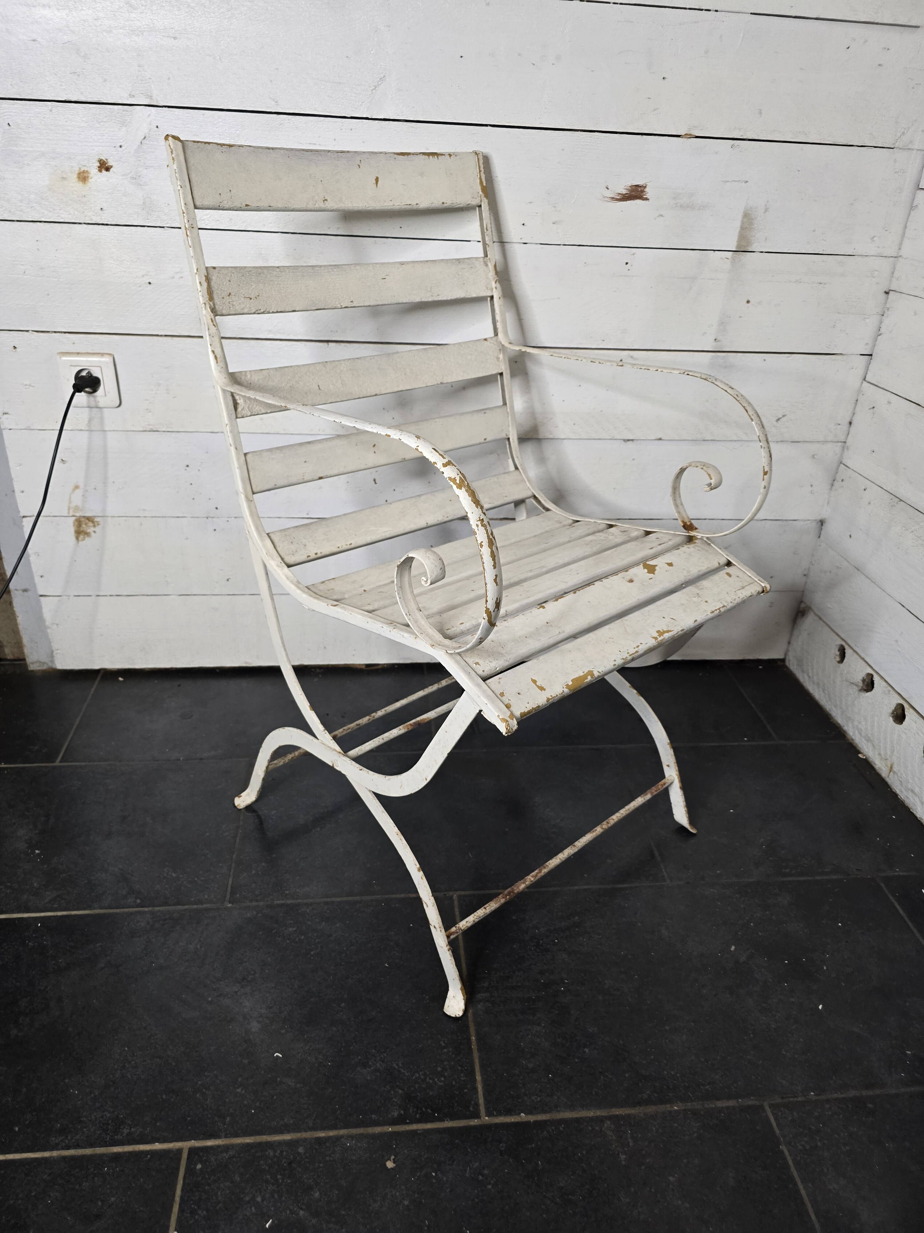 Old wrought iron and wood garden armchair