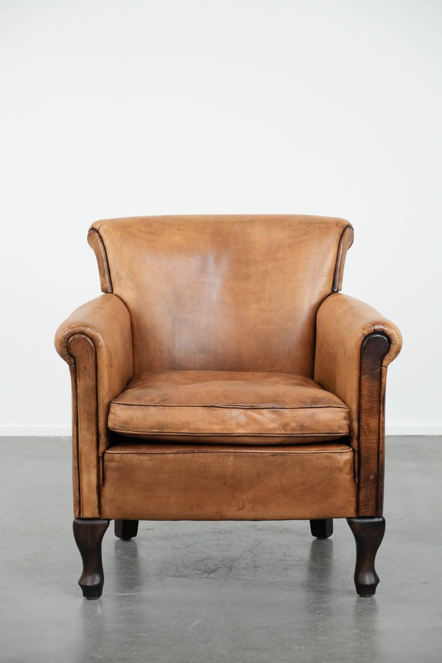 Vintage sheepskin armchair with a beautiful light colour and elegant legs