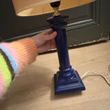 Corinthian column lamp base in blue with a lampshade of dried flowers.