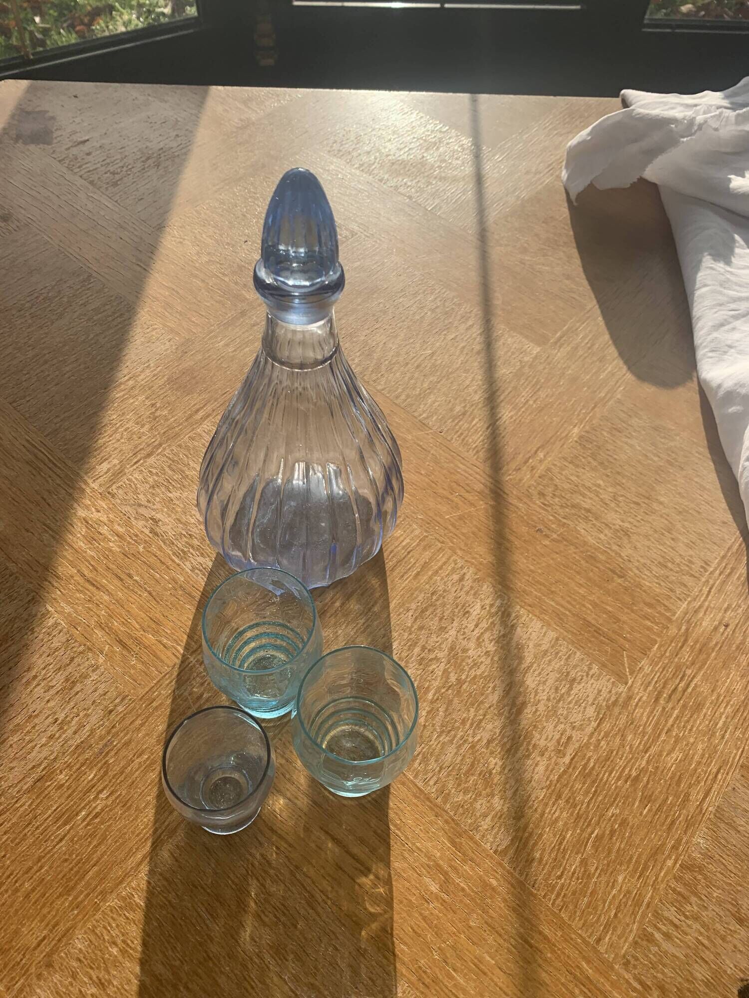 Liquor service consisting of a blue glass decanter and. 3 small antique glasses