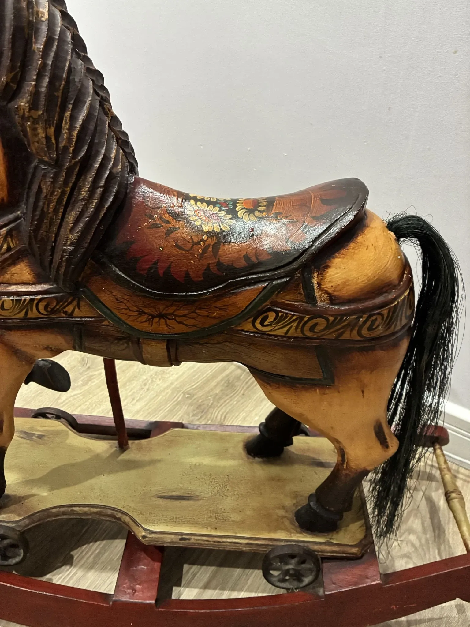 Antique hand-carved rocking horse on wheels, early 20th century