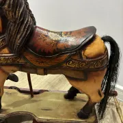 Antique hand-carved rocking horse on wheels, early 20th century