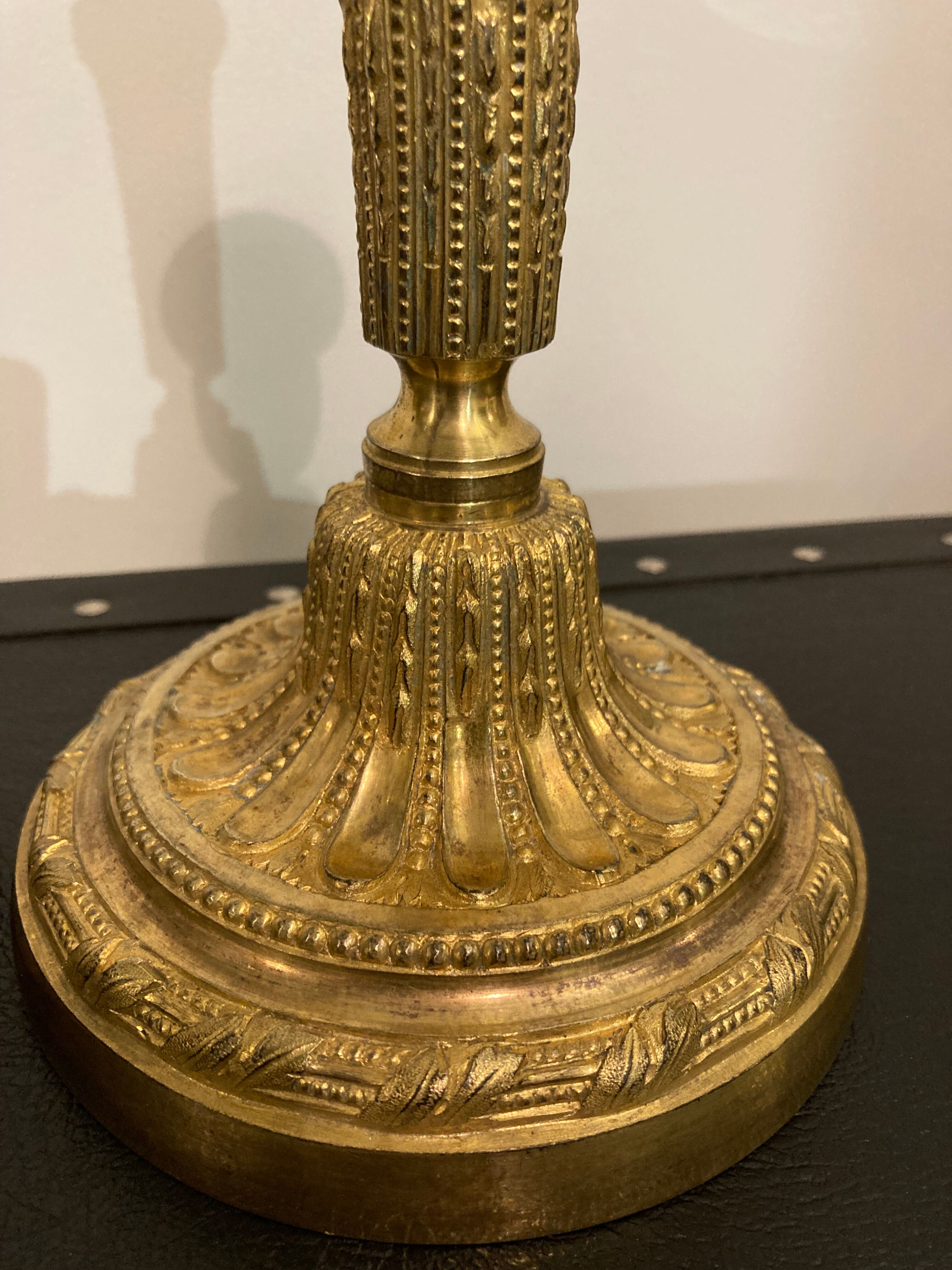 Pair of Louis XVI torch candlesticks in gilded bronze