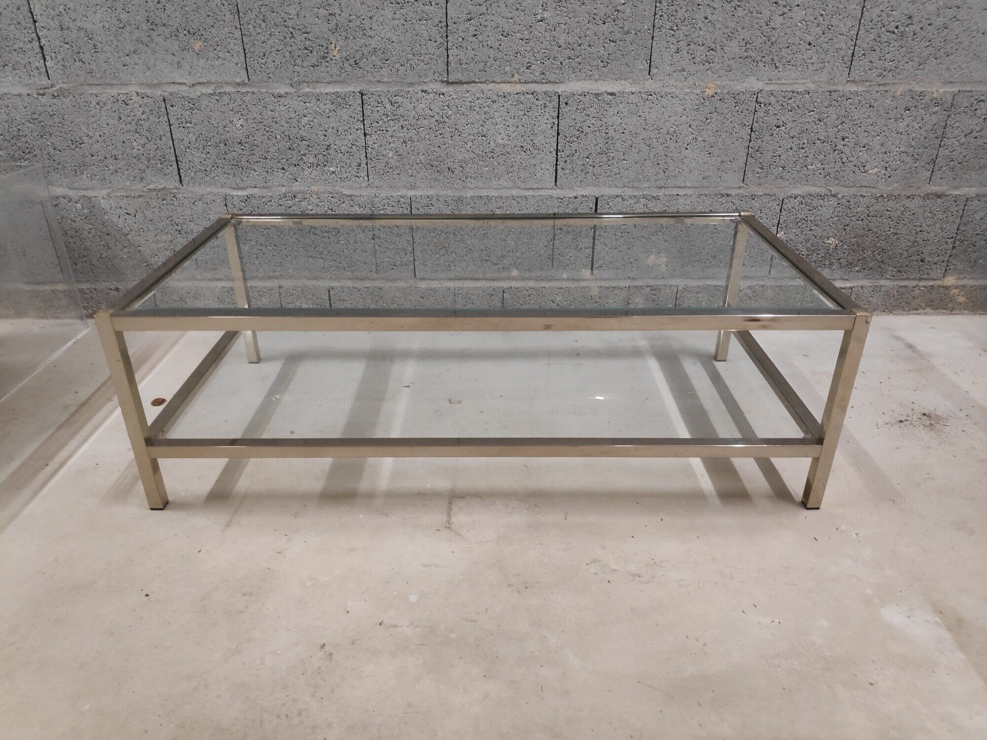Vintage bevelled glass coffee table and lightly gilded square metal tubes from the 70s/80s