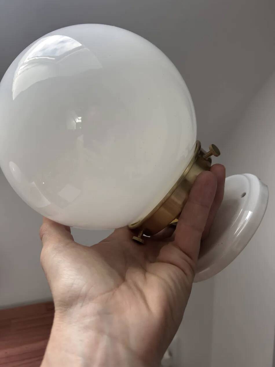Pair of wall sconces with white opaline globes