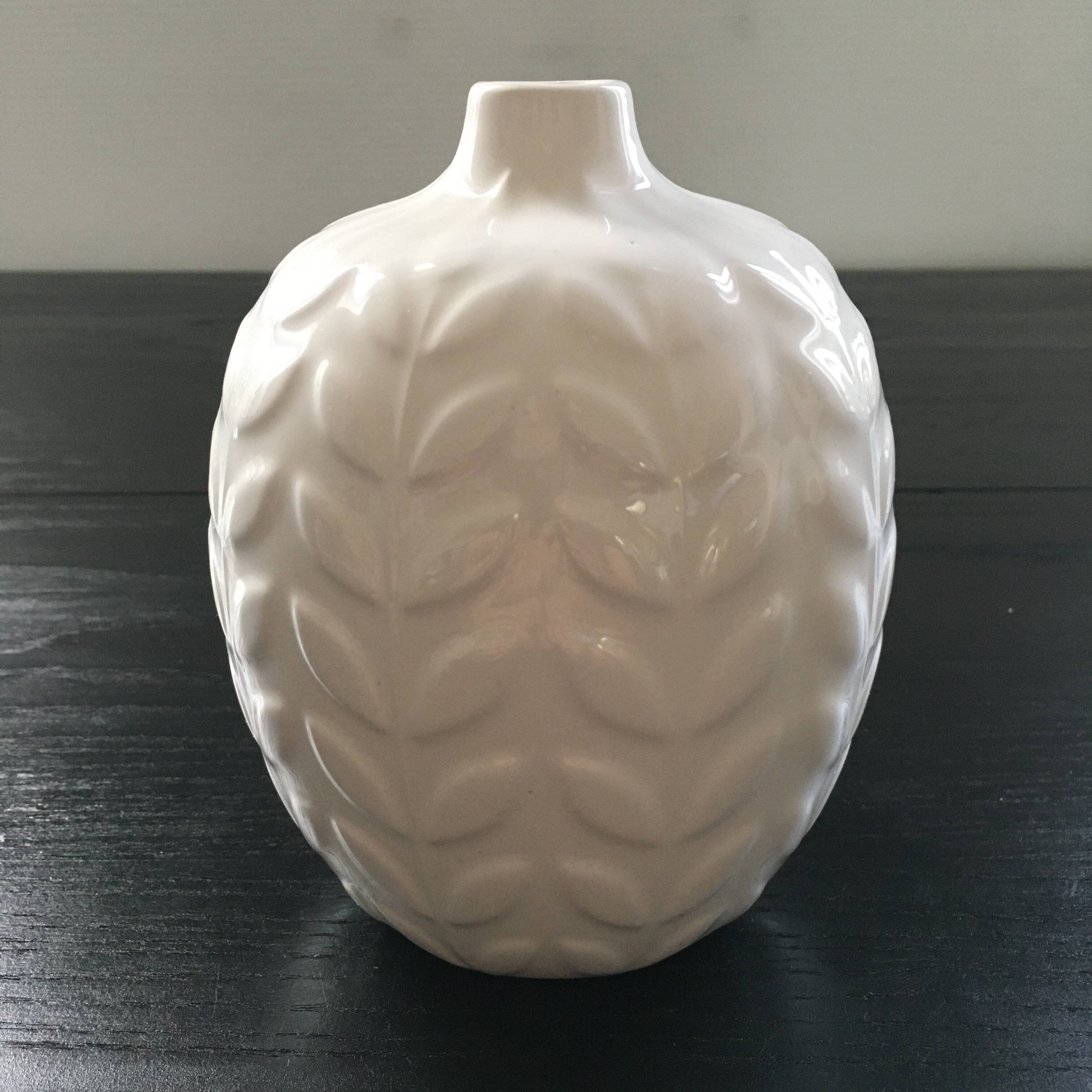 White vase with ear of corn decor