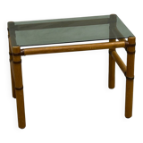 Blonde wood coffee table with smoked glass and leather bindings.